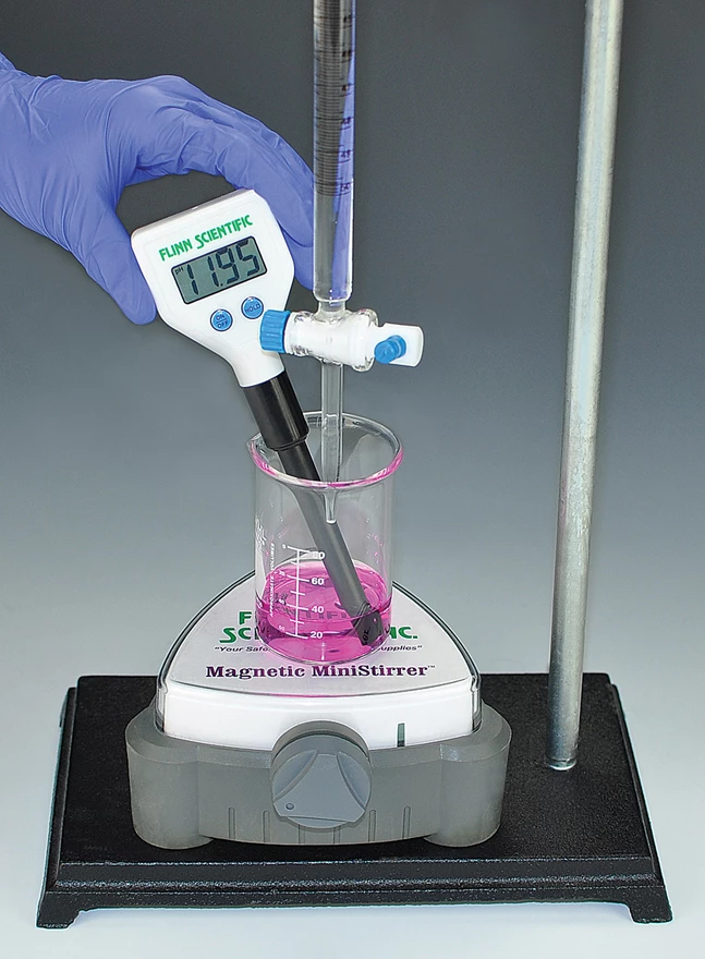 laboratory scene, the scientist holding the glass stirring rod